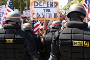 Police officers prevent protesters from entering the California State Capitol in Sacramento, CA, on May 1, 2020.